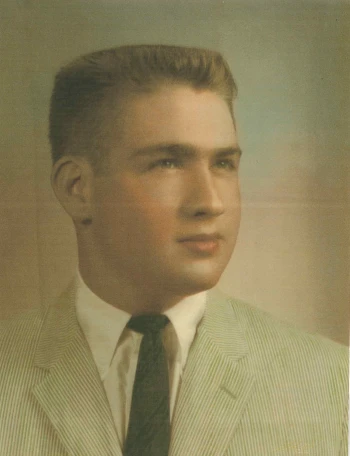 Michael Neidorff as a young man with a close trimmed haircut and soft lighting