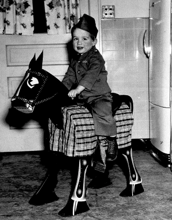 Michael Neidorff has a child sitting on a wooden horse